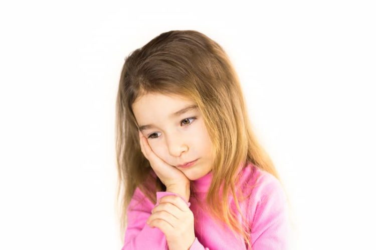 little-girl-with-sad-face-holds-her-cheek-with-han-2023-11-27-05-17-50-utc (1)