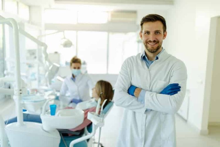 male-dentist-standing-with-his-hands-crossed-wear-2021-09-02-23-21-08-utc (1)